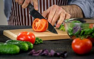 maschio mani taglio verdure per insalata foto