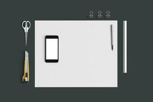 ufficio impostato con bianca lenzuola di carta, mobile Telefono e Stazionario su grigio sfondo foto