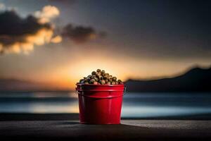 un' rosso secchio pieno con noccioline su il spiaggia a tramonto. ai-generato foto