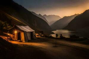 un' tenda è illuminato su a tramonto nel il montagne. ai-generato foto