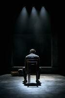 un' uomo seduta su un' sedia nel il buio ai generativo foto