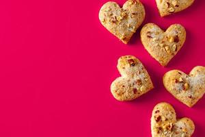 biscotti a forma di cuore per san valentino su sfondo rosa foto