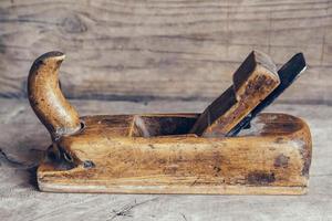 vecchio utensile manuale per la lavorazione del legno su un banco da lavoro in legno piatto sfondo lay foto