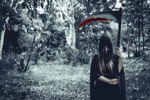 strega demone femmina con sanguinante mietitore foto