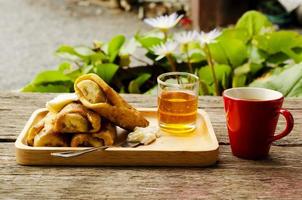 toast alla banana con miele e bevande calde al caffè sul tavolo di legno foto