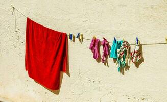 un' rosso asciugamano sospeso su un' clothesline foto