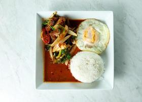 mescolare carne di maiale croccante fritta e pasta di peperoncino con riso, cibo tailandese foto