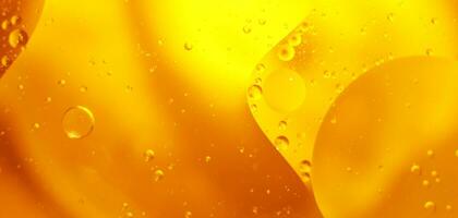 oro olio bolle vicino su. cerchi di arancia acqua macro. astratto brillante giallo sfondo foto