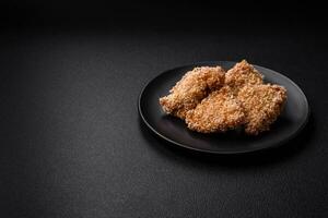 delizioso fresco croccante pollo pepite su un' buio calcestruzzo sfondo foto