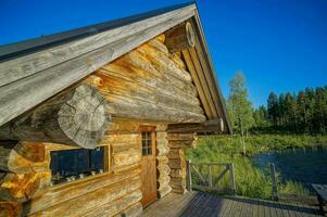 un' log cabina con un' di legno ponte e un' lago nel il sfondo foto