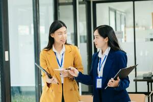 asiatico Lavorando insieme su un' progetto Due giovane attività commerciale colleghi Lavorando foto