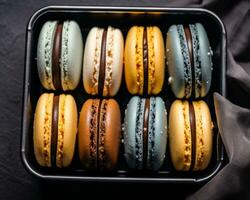colorato macarons nel un' metallo scatola su un' nero sfondo generativo ai foto