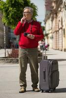 anziano uomo turista ha venire per il città su un' vacanza ma lui non lo fa conoscere quale modo per partire foto