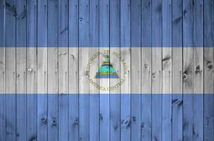 Nicaragua bandiera raffigurato nel luminosa dipingere colori su vecchio di legno parete. strutturato bandiera su ruvido sfondo foto