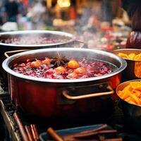 bevande frutta e frutti di bosco caldo vin brulé vino nel pentole. tradizionale Natale cibo nel calderone e pentola su fuoco sfondo. ai generato foto