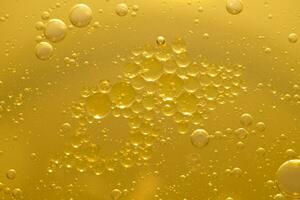 olio bolla struttura su oro sfondo. foto