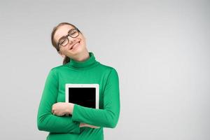 ragazza sorridente che abbraccia il suo ipad foto