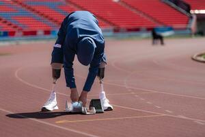 Disabilitato atleti preparare nel di partenza posizione pronto per correre su stadio traccia foto