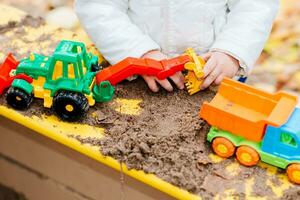 il bambino giochi macchine su il terreno di gioco foto