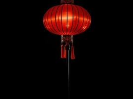 ai generato rosso e oro Cinese lanterne isolato su nero sfondo. asiatico nuovo anno rosso lampade Festival ai generativo foto