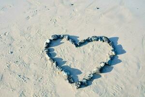 cuore sagomato rocce su il spiaggia foto