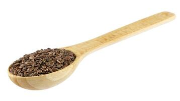 lino semi nel di legno cucchiaio isolato su bianca sfondo foto