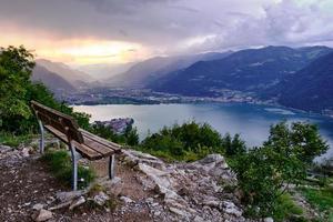 tramonto sul lago e panchina vuota foto