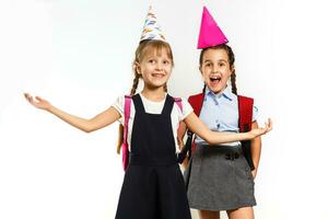 infanzia divertimento concetti Due poco studentesse nel compleanno festa cappelli foto