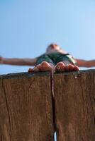 un' ragazzo è in piedi su un' di legno piattaforma foto