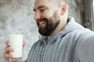 giovane uomo potabile latte foto