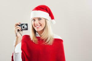 donna nel un' Santa cappello Tenere telecamera foto