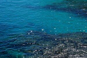 blu acqua e rocce nel il oceano foto