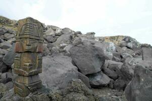 un' lavorato di legno figura su superiore di un' roccioso la zona foto