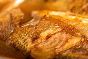 piatti tradizionali cinesi da banchetto, pesce di mare bollito con salsa gialla foto