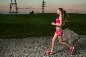 in esecuzione donna. corridore jogging nel soleggiato natura. foto