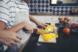 la famiglia felice ha papà, mamma e la loro piccola figlia che cucinano insieme in cucina foto