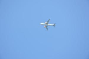 decollo di un aereo passeggeri contro il cielo blu foto