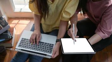 due studentesse universitarie usano un tablet e un laptop per studiare online a casa per prevenire l'epidemia del virus covid-19.
