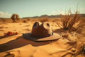 ai generato elegante cappello riposa contro il fondale di sabbioso deserto dintorni foto