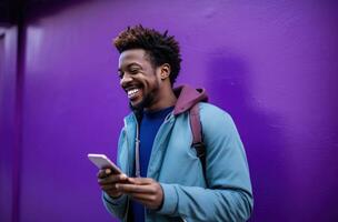 ai generato un' sorridente uomo guardare a il suo Telefono mentre in piedi su un' viola strada parete foto