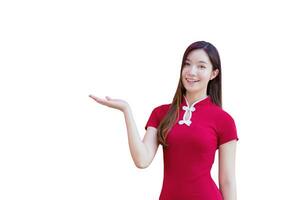bellissimo giovane asiatico donna con lungo capelli chi indossa rosso cheongsam vestito mentre isolato su bianca sfondo. foto