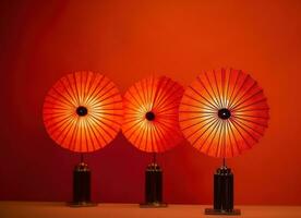 ai generato tre Cinese lanterne con fan su rosso sfondo, foto