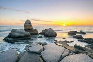 ai generato bellissimo rocce su il spiaggia a Alba. professionista foto