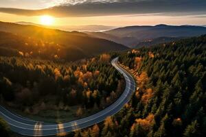 ai generato aereo Visualizza di montagna strada nel foresta a tramonto nel autunno. superiore Visualizza a partire dal fuco di strada nel boschi. bellissimo paesaggio con carreggiata nel colline, pino alberi, verde prati foto