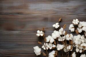 ai generato cotone fiori su di legno sfondo foto