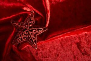 astratto Natale sfondo con stella su un' rosso velluto sfondo. foto