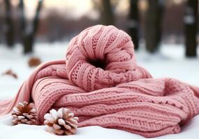 ai generato caldo rosa lana sciarpa nel il neve. inverno volta. foto