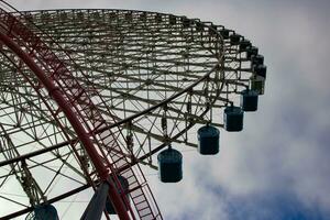 un' Ferris ruota dietro a il blu cielo nel Yokohama soleggiato giorno Basso angolo foto