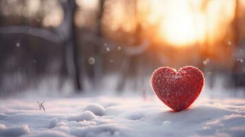 ai generato rosso cuore nel neve contro tramonto, simboleggiante inverno amore foto