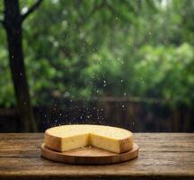 ai generato pezzo di formaggio su di legno tavolo con verde bokeh sfondo foto